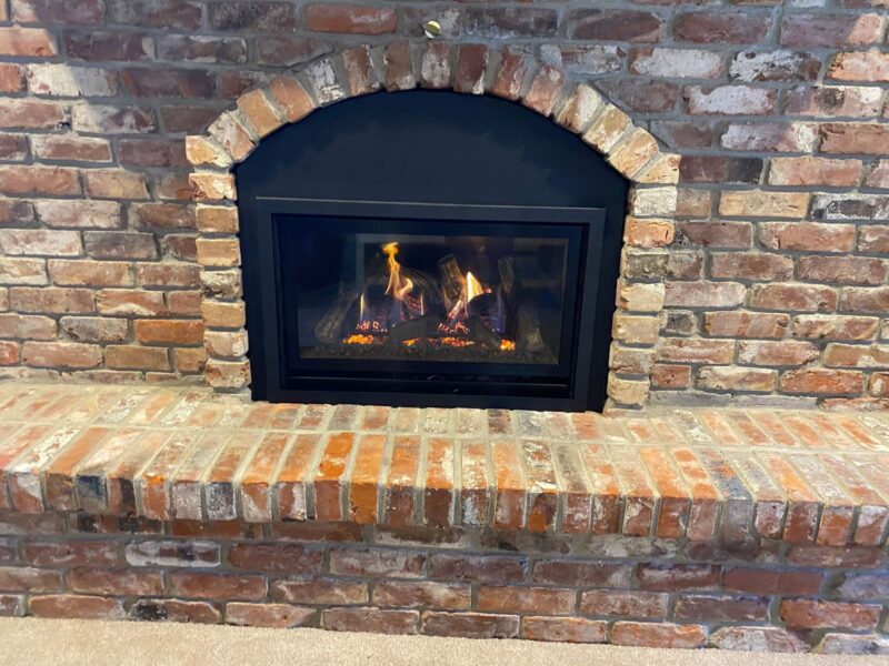 brick fireplace with roaring fire